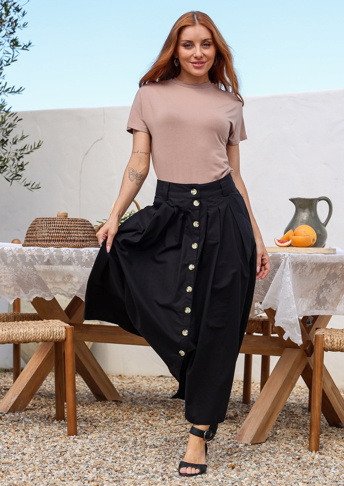 Woman wearing a basic t shirt with a high crew neckline paired with a skirt