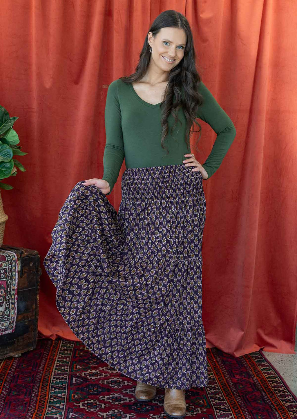 Woman flaunting a beautiful floral printed cotton maxi skirt with tiers adding volume to it.