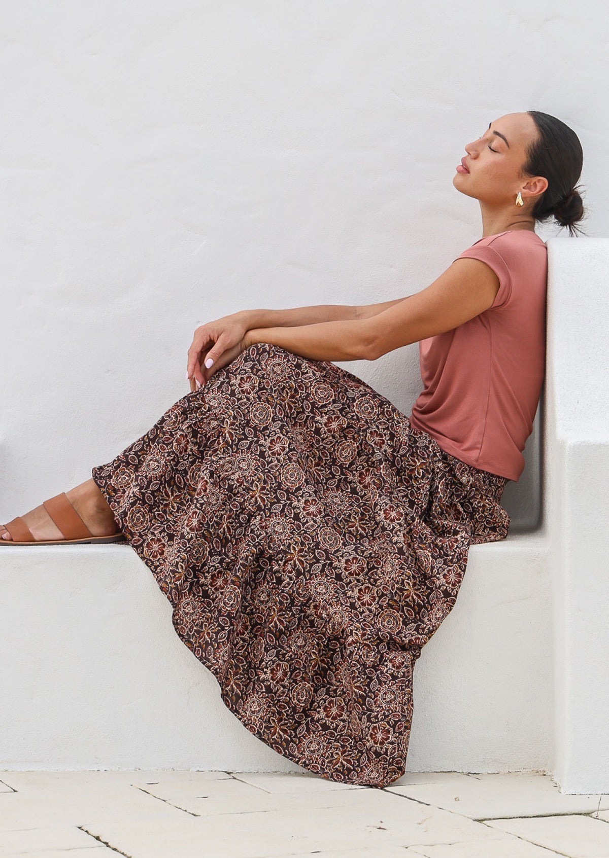 Model wears floral printed, cotton tiered maxi skirt with wide elasticated waistband.