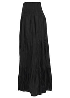 Side view of black cotton flowy tiered maxi skirt with elasticated waistband 