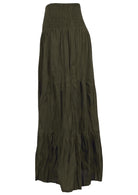 Side view of long cotton skirt in olive green featuring 3 tiered style and shirring across the waist.