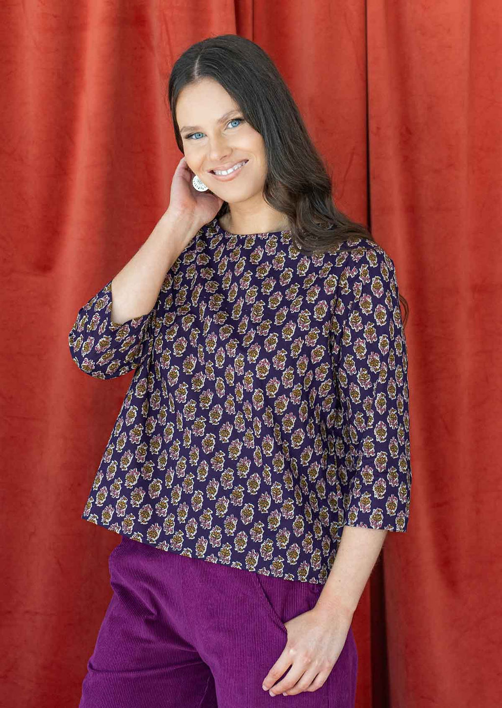Model pairing a beautiful floral printed cotton top in dark purple with esta corduroy pants in plum shade.
