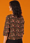 back view of woman in boxy cotton floral blouse