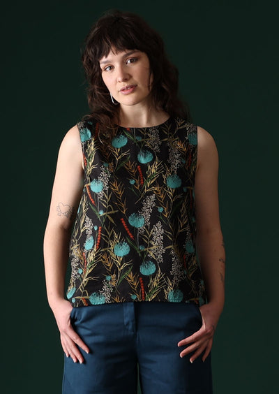 Model wears Eden Top Thistle sleeveless high round neckline cotton top with button at nape and slight concave front hem | Karma East Australia