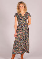 Model wearing navy floral rayon wrap maxi sundress 