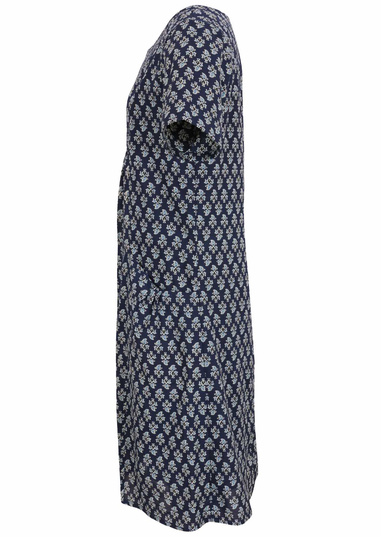 Side view of cotton dress with round neckline and short sleeves in navy blue based floral print. 