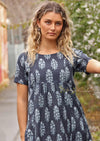 Woman in lane way with navy blue cotton Indian print summer dress