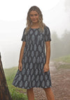 Woman standing on misty mountain top wearing navy blue cotton Indian print summer dress