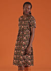 Woman wears round neck knee length floral cotton dress