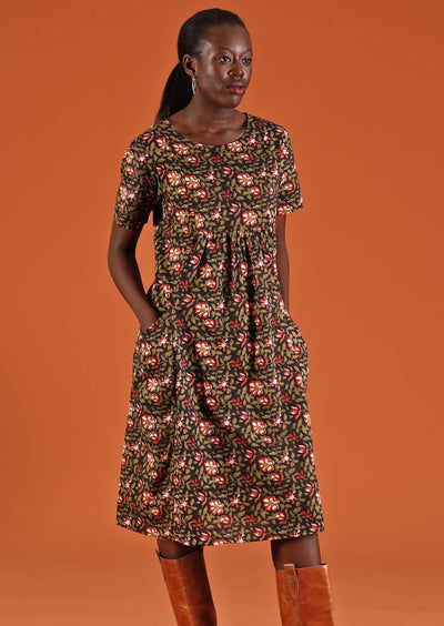 Woman has hands in pockets of a floral dress