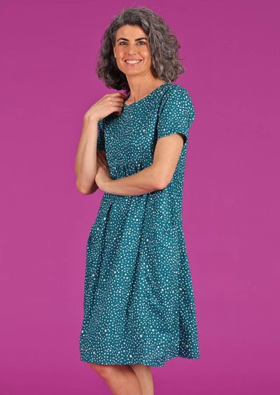 Woman in cotton dress teal base with polkadots dress with pockets