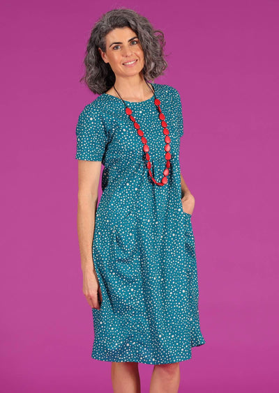 Woman in cotton teal polkadot loose dress with pockets