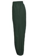 Side view of wide leg cotton harem pants in jungle green with hidden side pockets and elastic waist