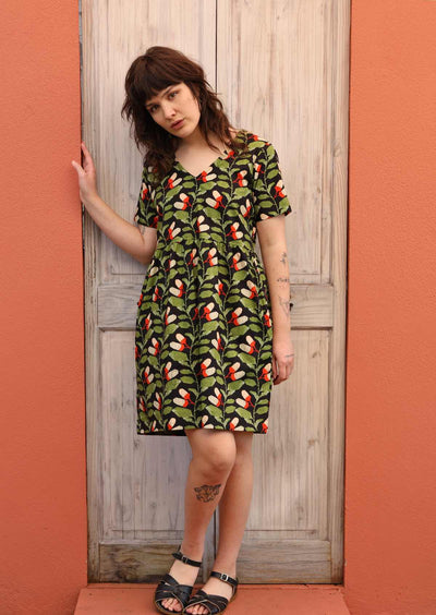 Model wears loose fit above knee cotton dress