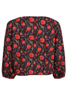 Cotton long sleeve top with boat neckline and bishop sleeves, in red and green floral print on a blue base