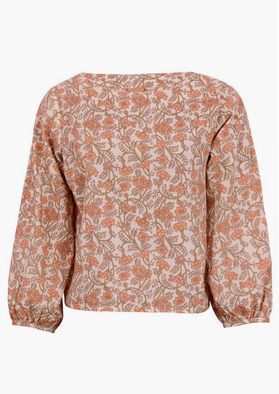 Model in cotton floral women's top, cream with apricot coloured flowers