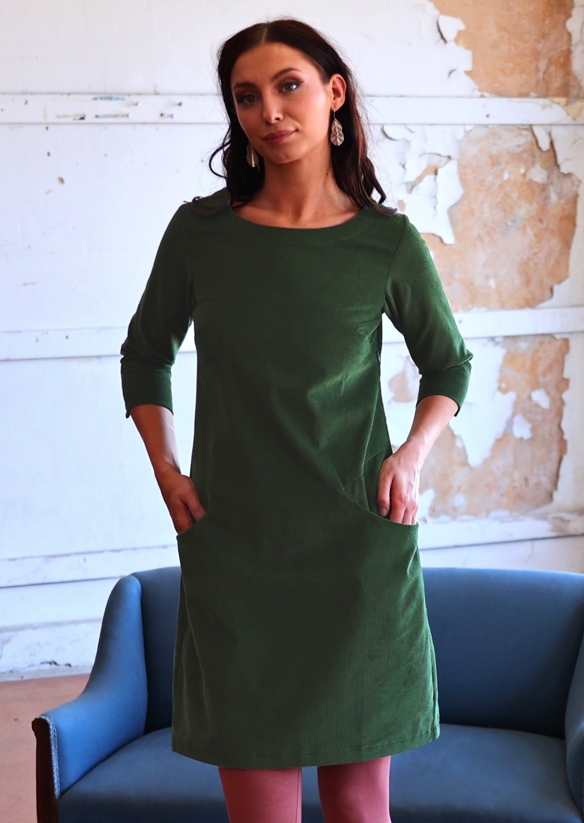 Woman wearing green corduroy A-line dress 