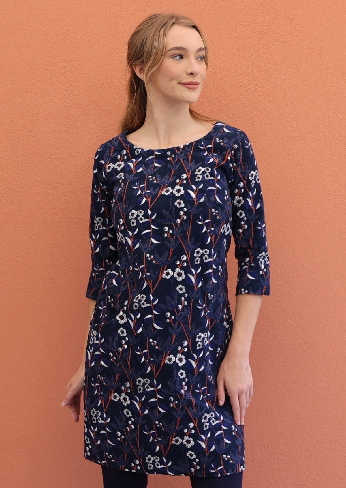 Model wears  floral printed cotton corduroy 3/4 sleeve dress in navy blue.