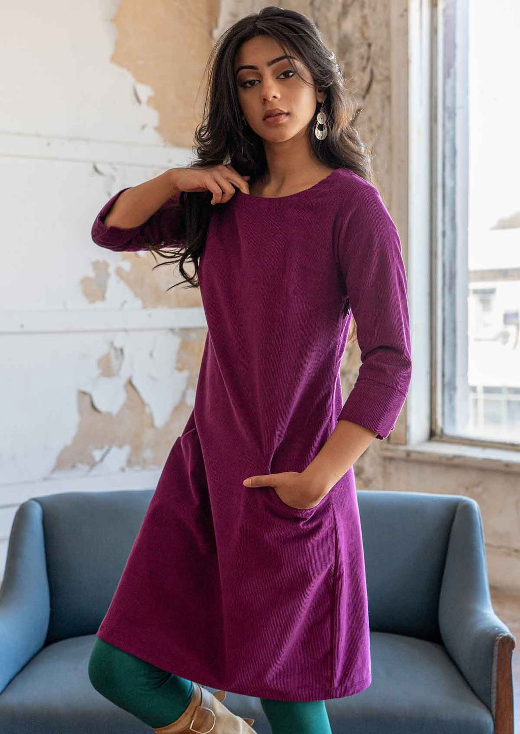 Woman wearing 100% cotton 3/4 sleeve corduroy shift dress with one hand in pocket