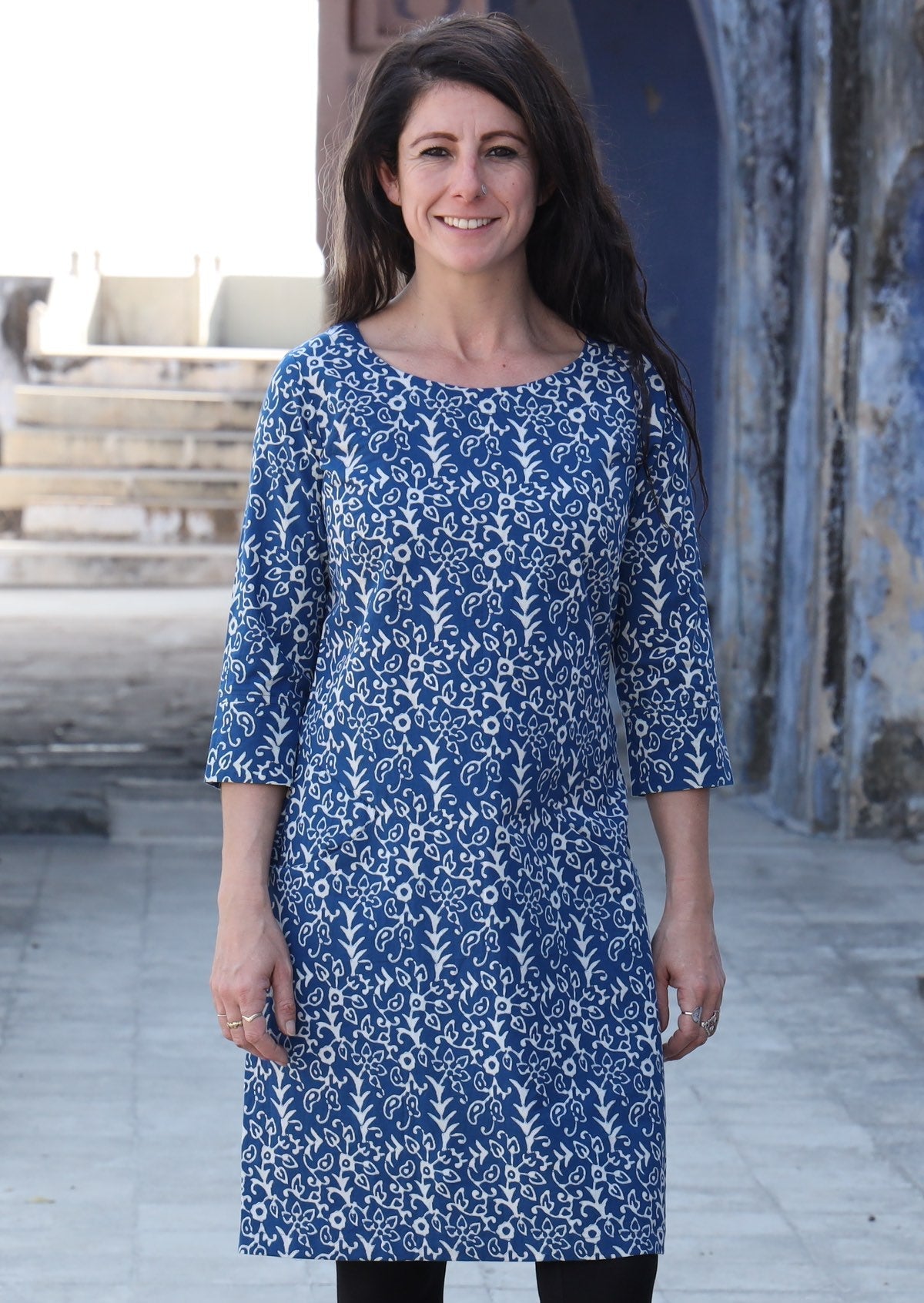 Woman standing wearing 100% cotton blue and white dress 