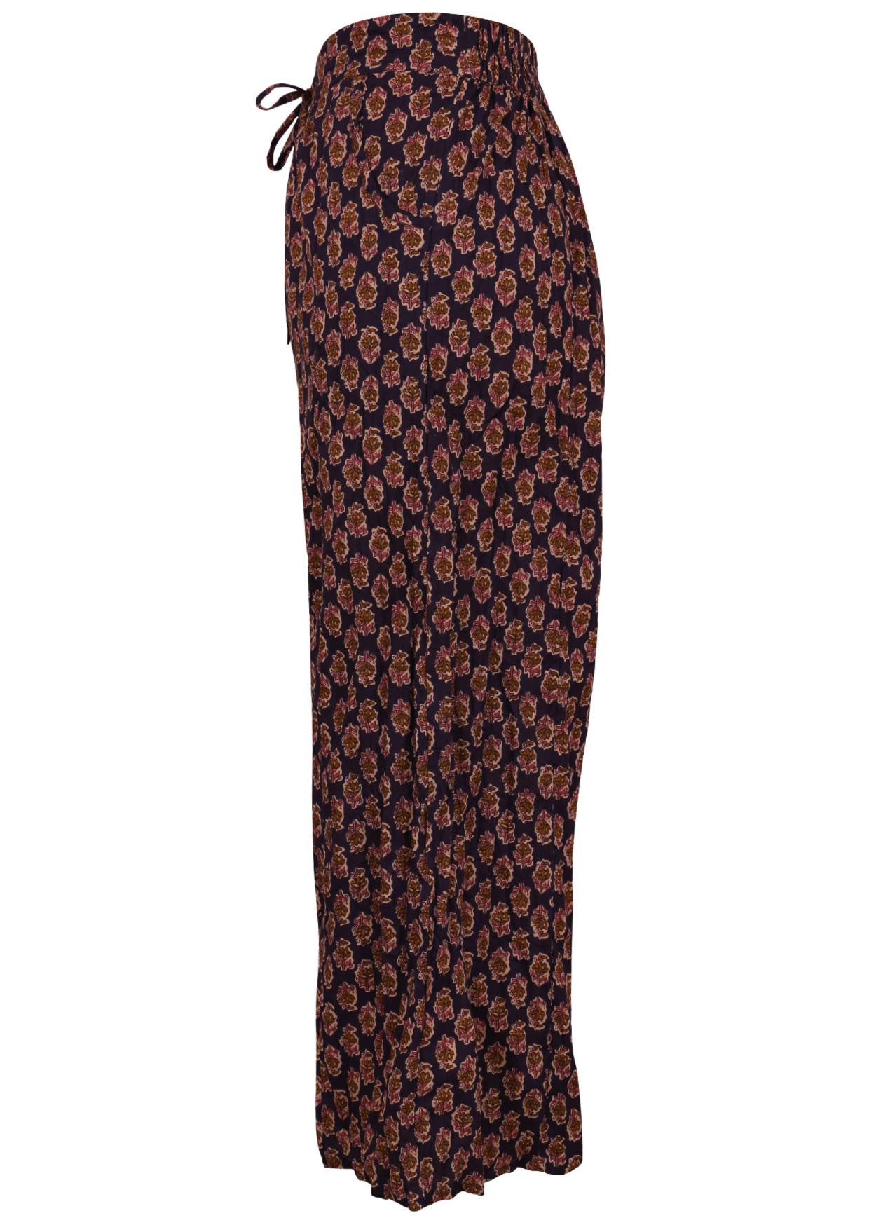 Relaxed fit cotton pants in dark purple based floral motif print with drawstring and pockets.