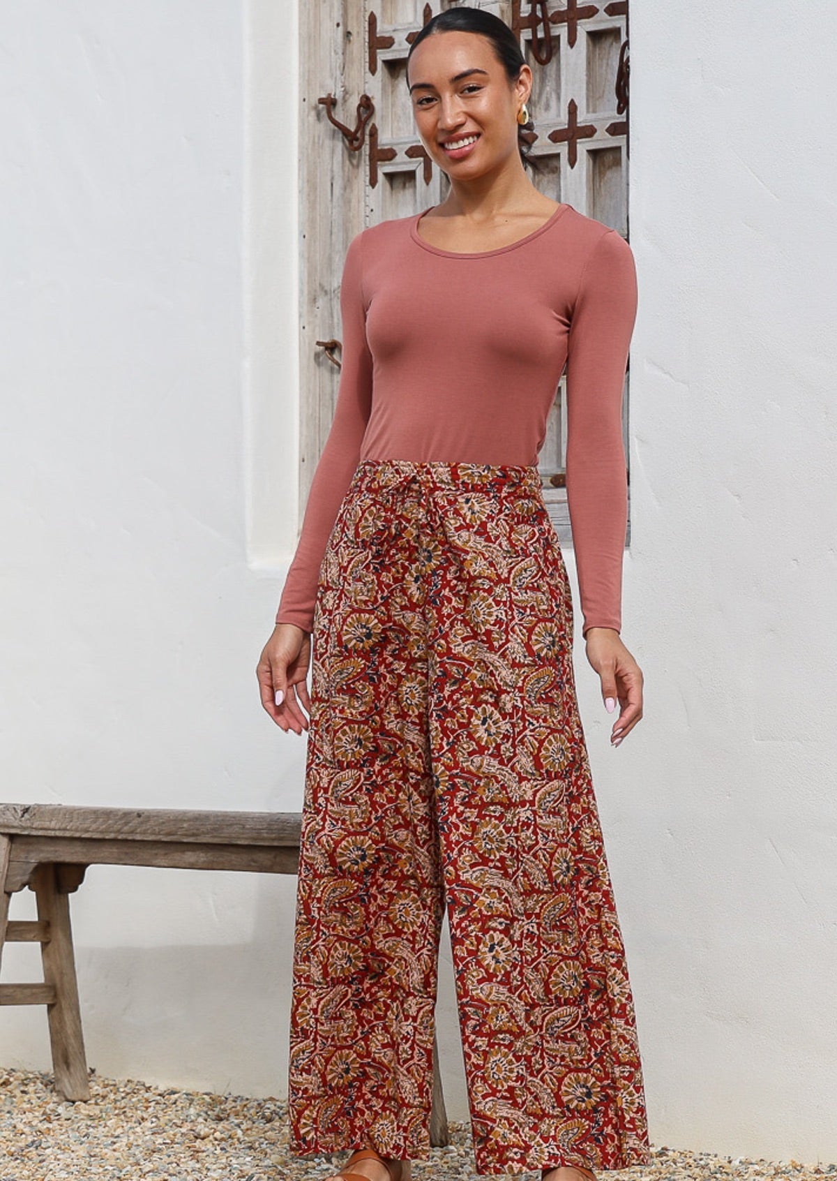 Model wears wide leg cotton high waisted pants with drawstring and deep pockets.