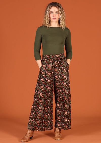 Model in Janis Pants Wild Rose wide legged cotton women's pant with pockets and long sleeve green top