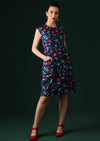 Model wears knee length dress with cap sleeves.