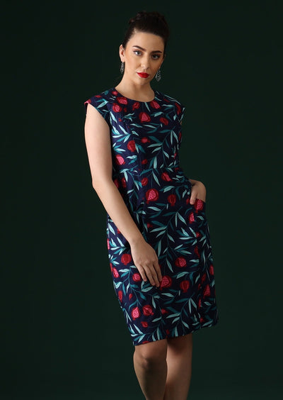 Model wears fruit print dress with pockets.