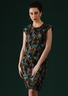 Model wears black based dress with floral pops of blue and red.