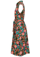 Side view of olive green based floral print cotton dress with pockets.
