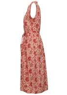 Side view of cream based floral print cotton dress with pockets.