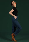 Model wears rich blue drill cotton straight leg pants and black fitted tee