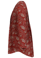 Red based floral print cotton button through shirt with long sleeves, that is longer at the back