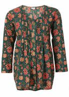 Green based floral print cotton button through shirt with pin tucks across the bodice and a V-neckline