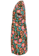 Side view of loose fitting cotton dress in olive green with short sleeves and hidden side pockets 