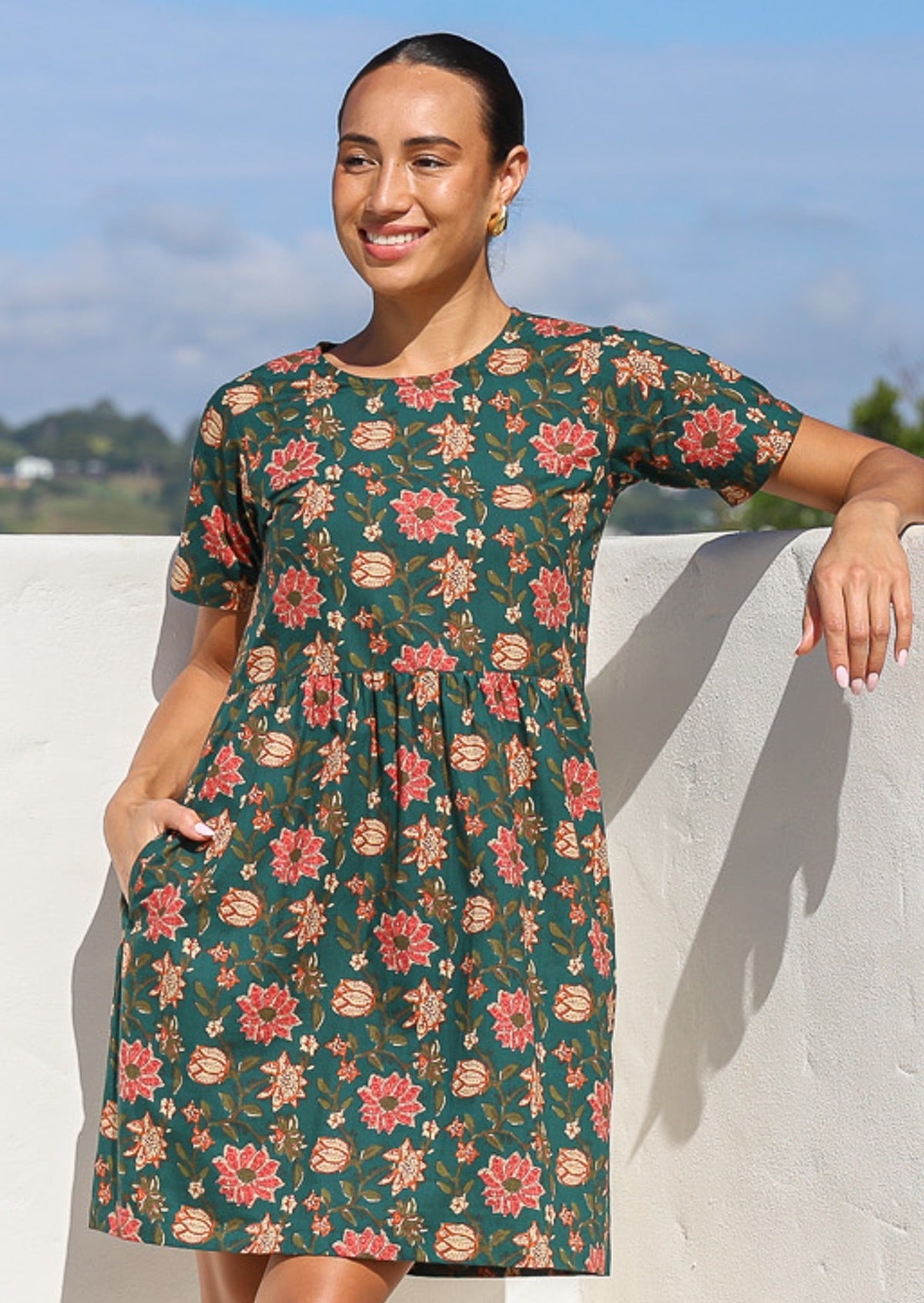 100% cotton relaxed fit, floral print dress with short sleeves, pockets and high round neckline.