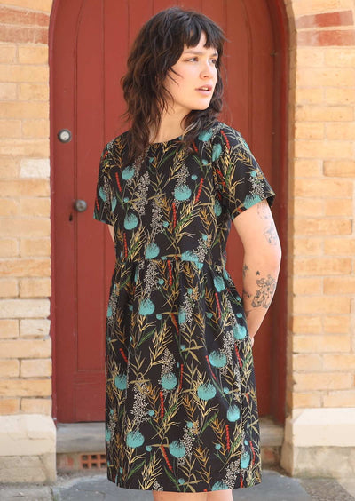Model wears shirt sleeve black base cotton dress