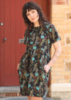 Model wears loose fit cotton dress with pockets