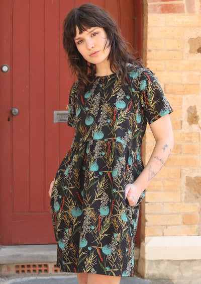 Model wears loose fit cotton dress with pockets