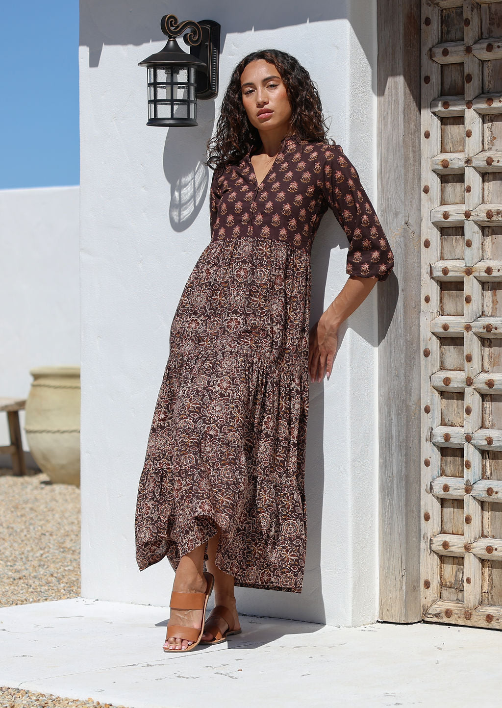 Woman wearing a  Cotton maxi dress standing against a white wall 