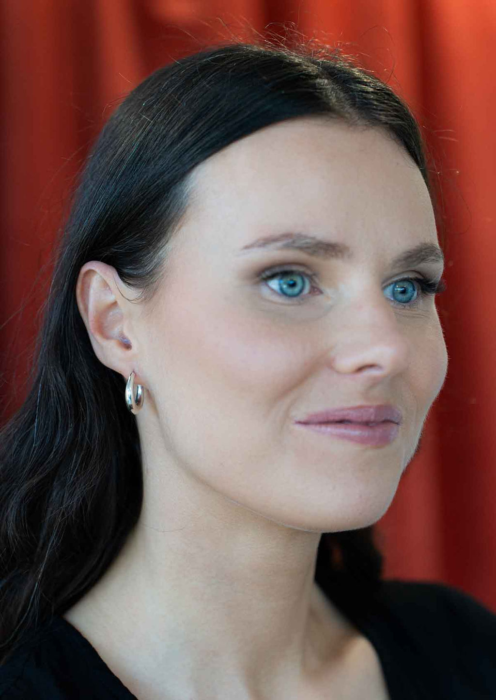 woman wearing medium sized silver hoop earrings 92.5 Sterling Silver
