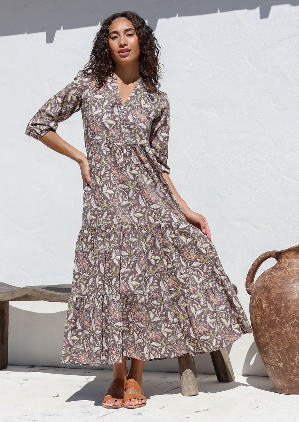 Model wearing 100% cotton flowy three tiered maxi dress with buttoned bodice, 3/4 sleeves and hidden side pockets 