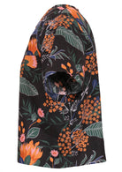 Side view of cotton loose fit boxy top with short sleeves in black based gorgeous protea print 