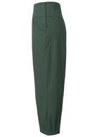 Side view of wide leg tapered cotton pants in plain green with side zipper and pockets