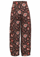 Front view of 100% cotton wide leg cotton pant with black based floral print with pockets.