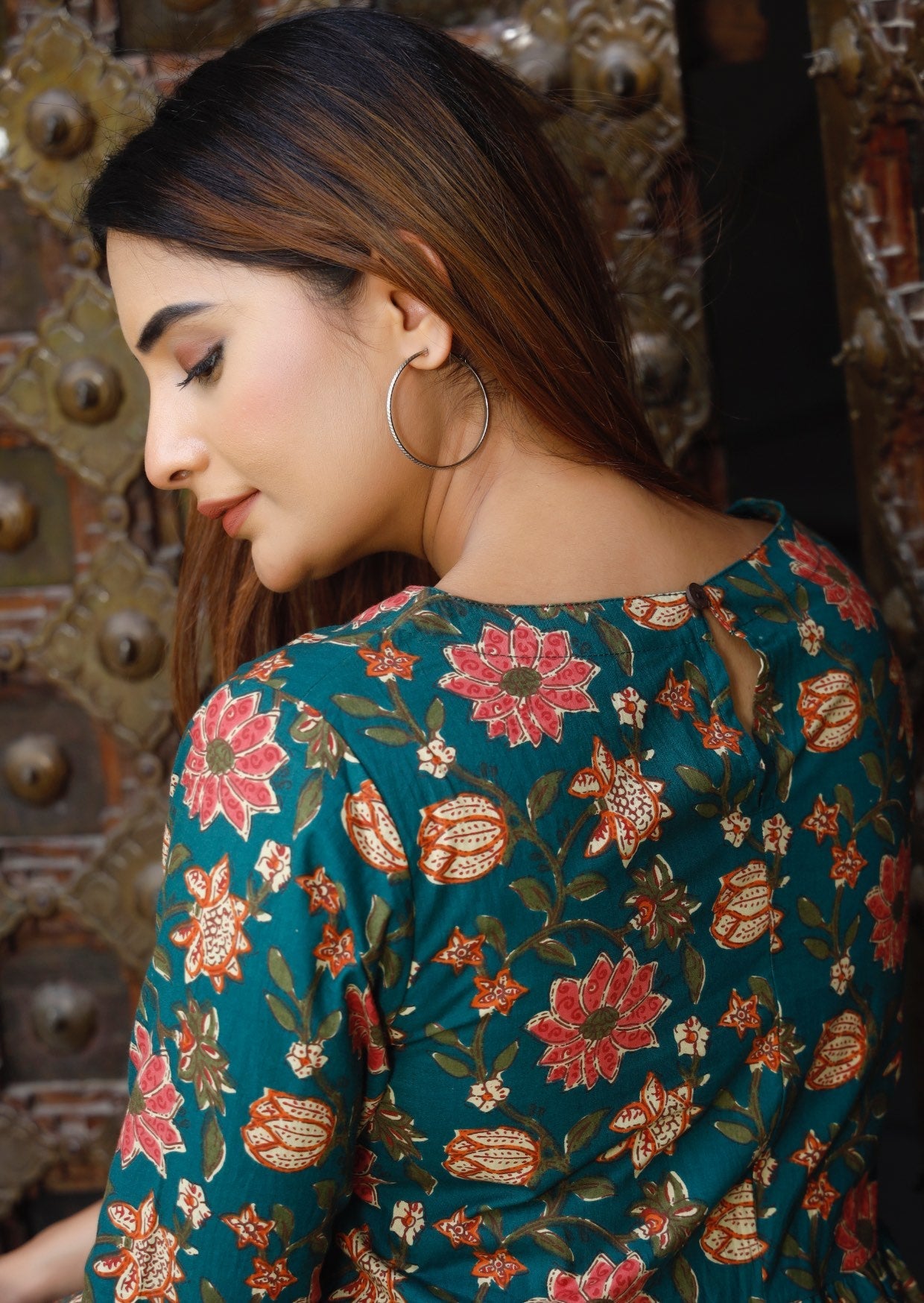 Beautiful floral print on dark green base, dress with keyhole button back closure.