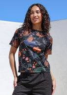 Model wears 100% cotton black based botanical print top with pink and orange florals