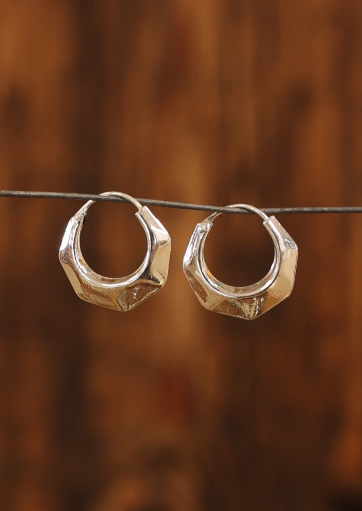 Sterling silver hollow hoop earrings with six 'sides' and subtle faceting and hinged wire closure