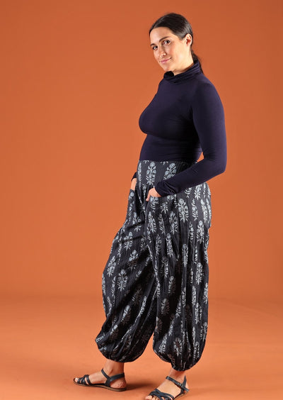 Model wearing Pilot Pant Delphi navy blue Aladdin pant with turtle neck top